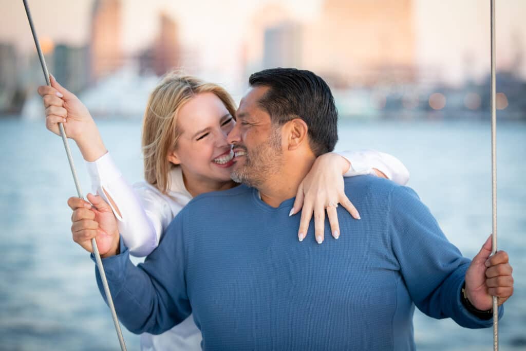 A man and woman enjoy a sunset sail around San Diego Bay