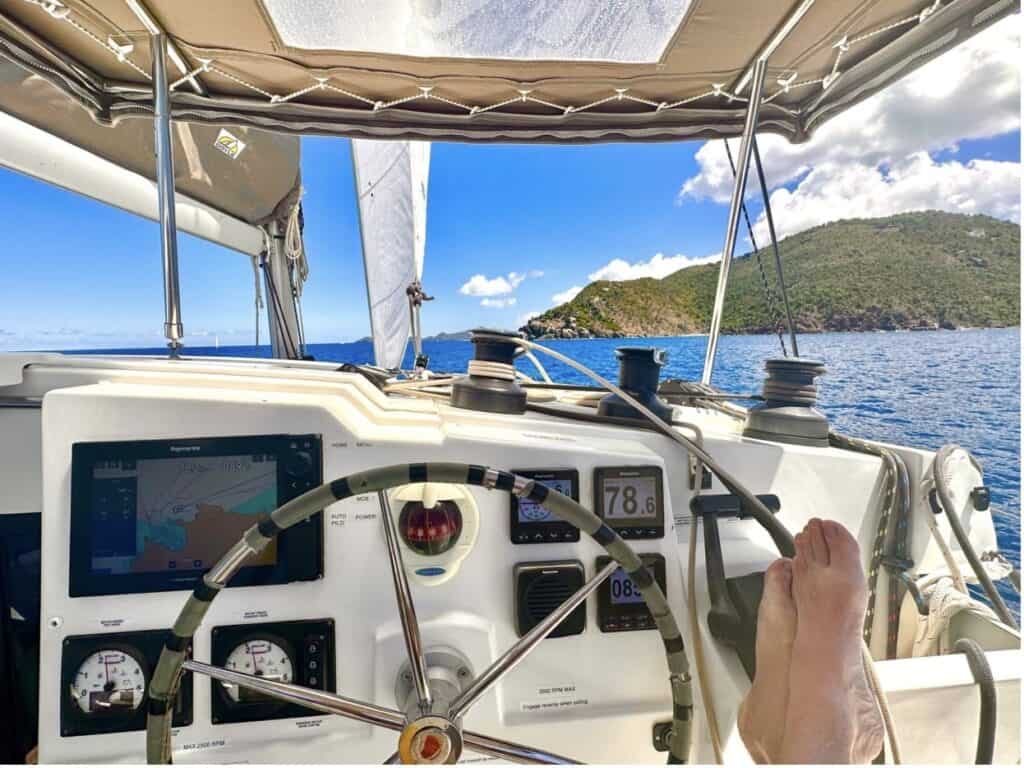 A captain's view lookign out on the ocean from behind the wheel of his boat. 