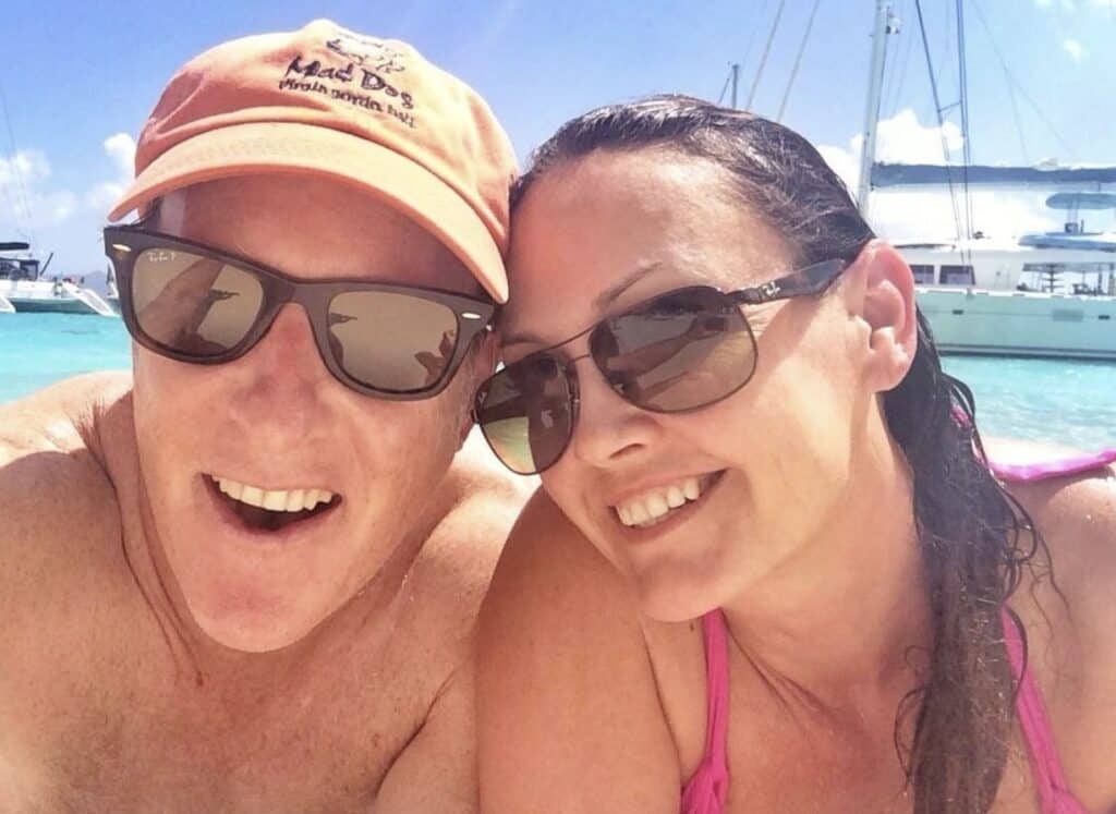 Paul and Victoria smile while lounging aboard their Catamaran in the British Virgin Islands.