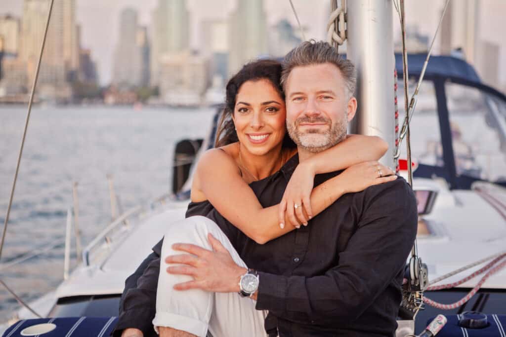 Couple posing on the deck of the Riviera sailboat