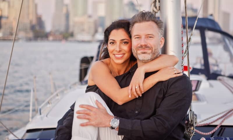 Couple posing on the deck of the Riviera sailboat