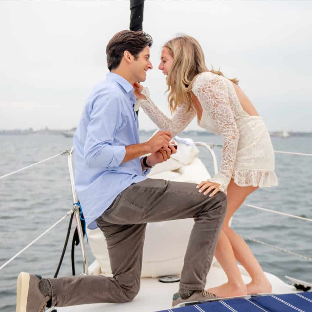 Couple on boat, with the male getting ready to propose to his girlfriend.