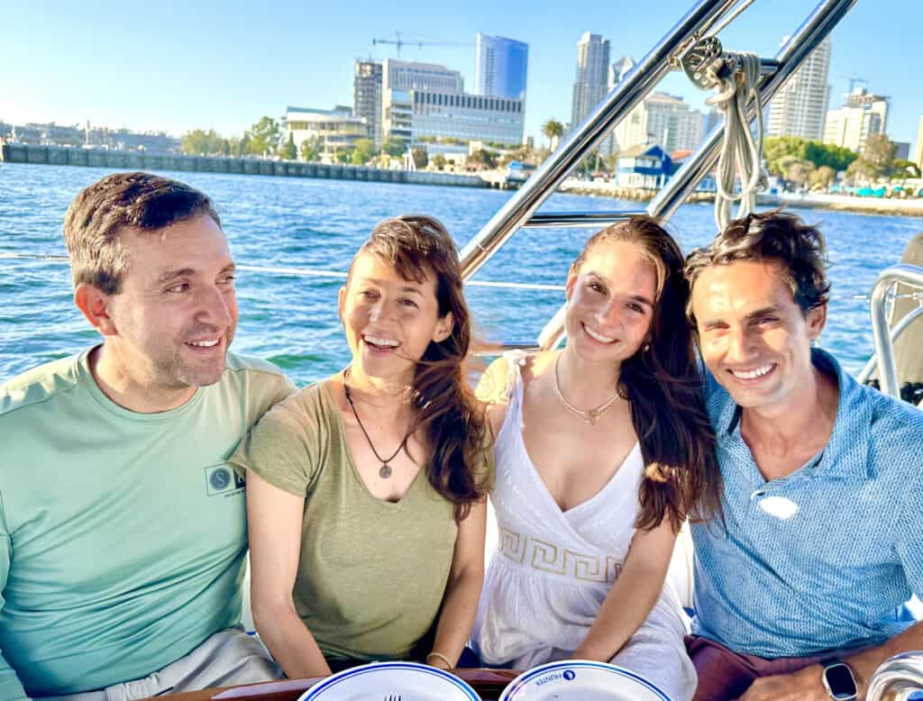 Couples smiling on the deck of the Riviera sailboat, sailing in the San Diego Bay