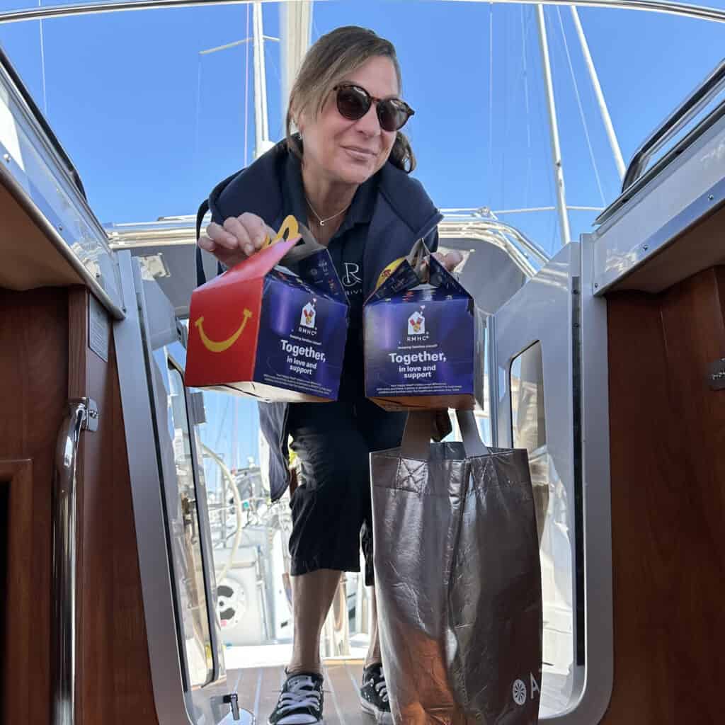 Riviera sailboat attendant holding two Happy Meal boxes