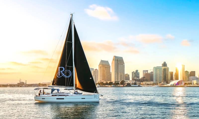 Riviera sailboat on the San Diego Bay, with the SD skyline and Rady's Shell in the background.