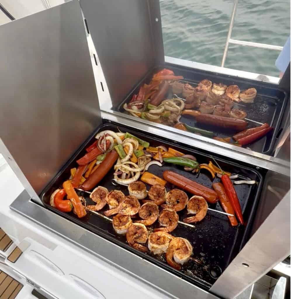 Cooktop of the Riviera sailboat. Grilling shrimp, veggies, and hotdogs.