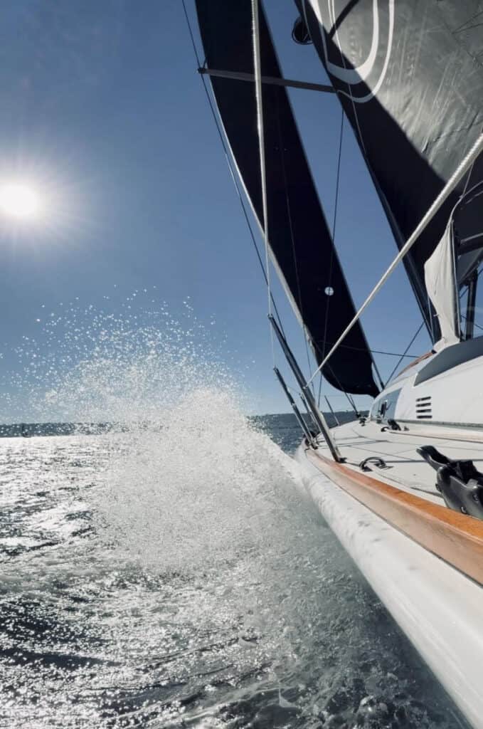 Riviera sailboat spraying water as it glides through the San Diego Bay