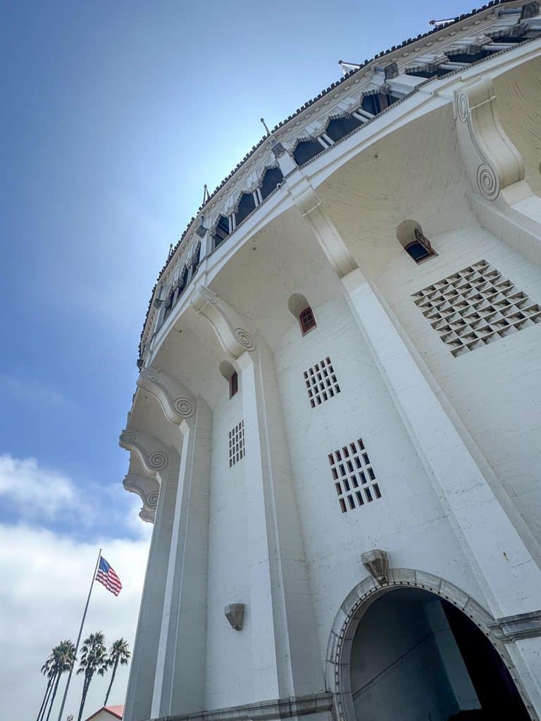Close-up of the white exterior of the San Diego waterfront building with an American flag.