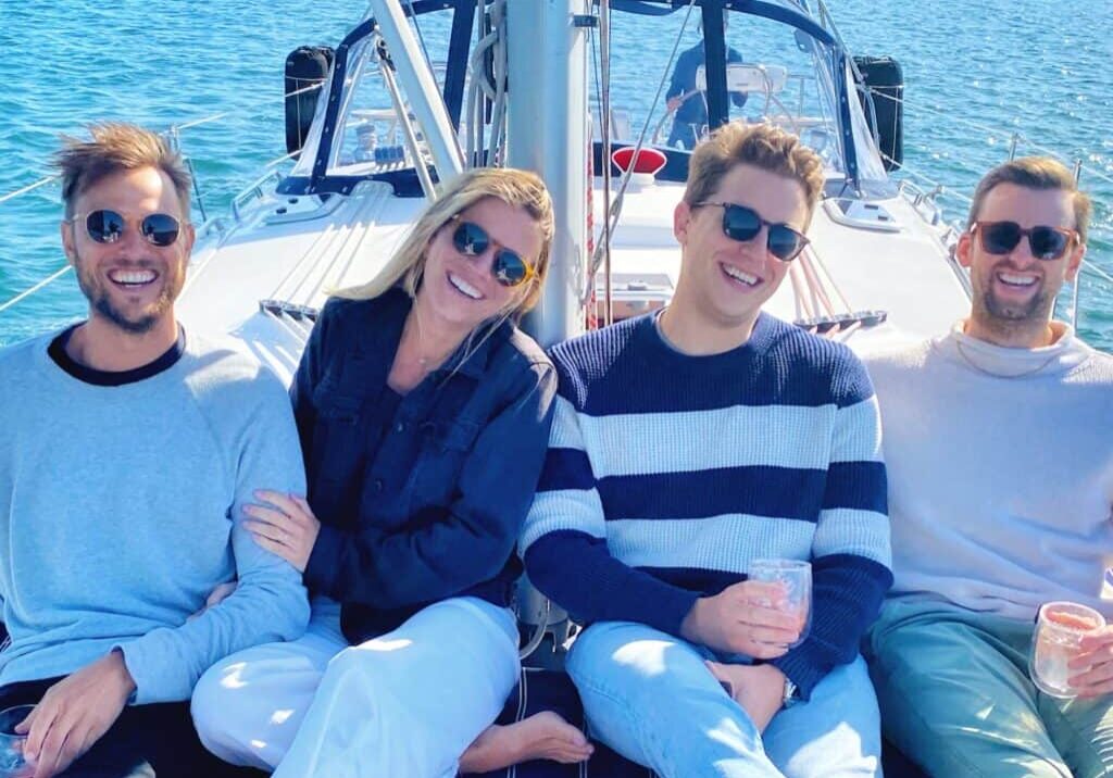 Friends pose and smile as they enjoy a day sail along San Diego Bay