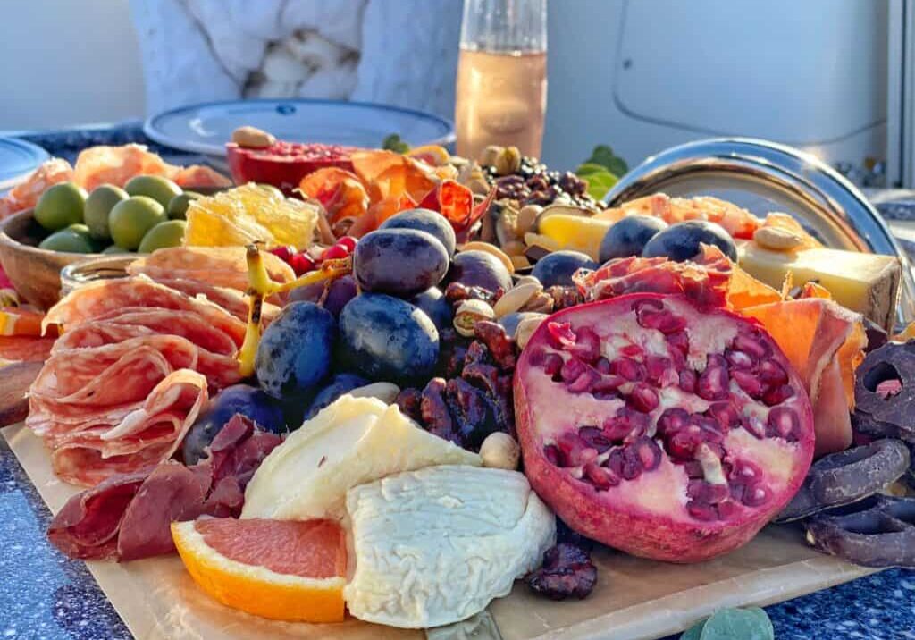 Brunch platter including fruits and cheese is served on the boat.