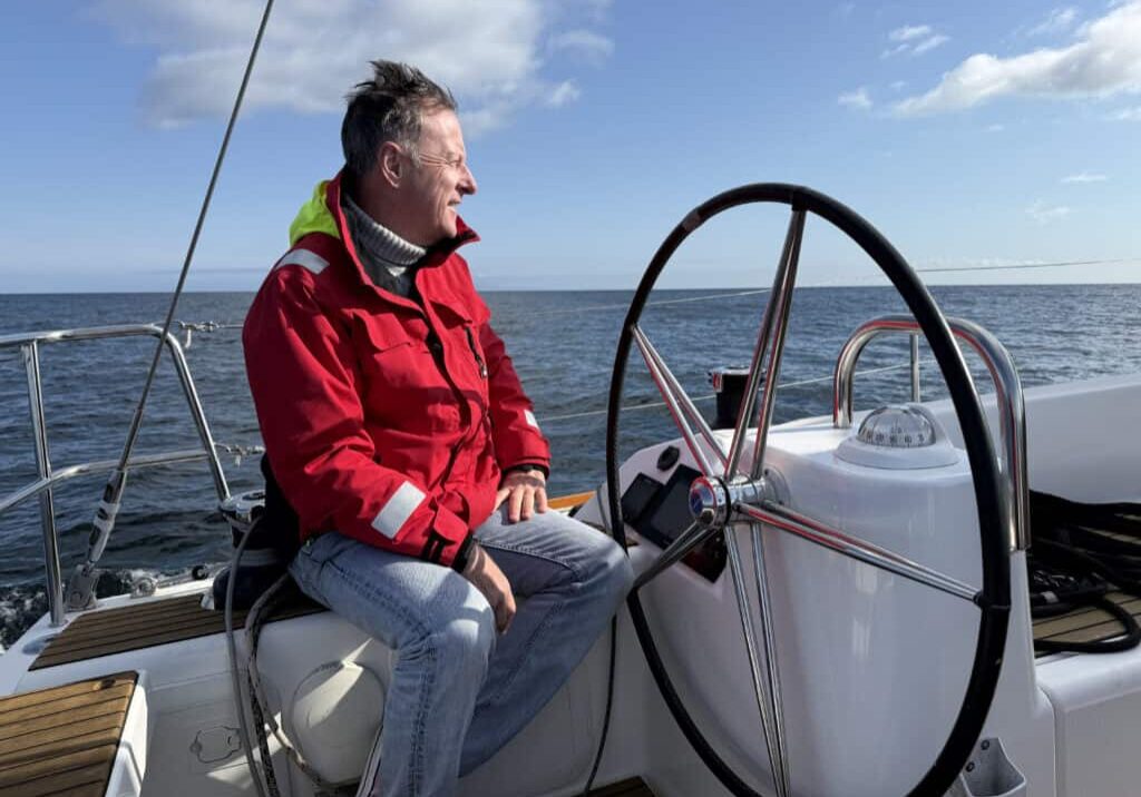 At The Helm Captain Paul Barnett at the helm of the Riviera