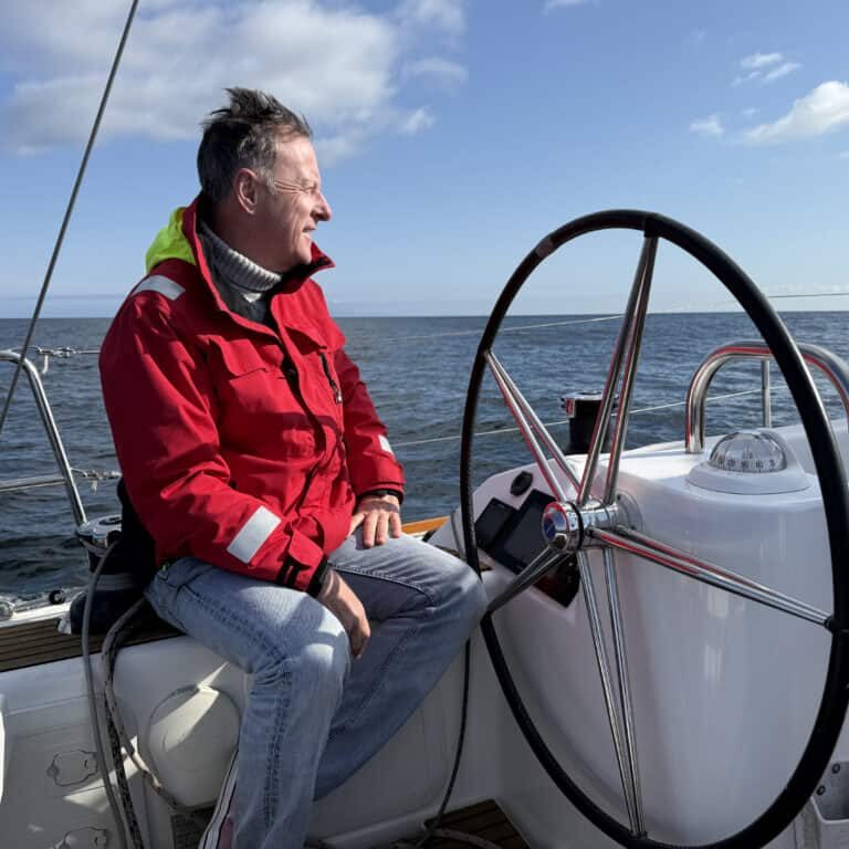 At The Helm Captain Paul Barnett at the helm of the Riviera